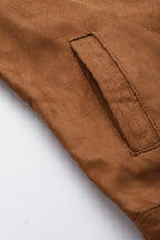 Close-up of the brown suede faux leather jacket showcasing the sleek texture and classic pocket detail.